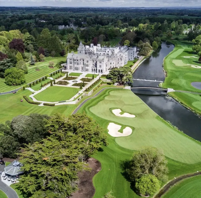 Aerial view of Adare Manor house, formal gardens and golf course beside the River Maigue in Adare, County Limerick, Ireland